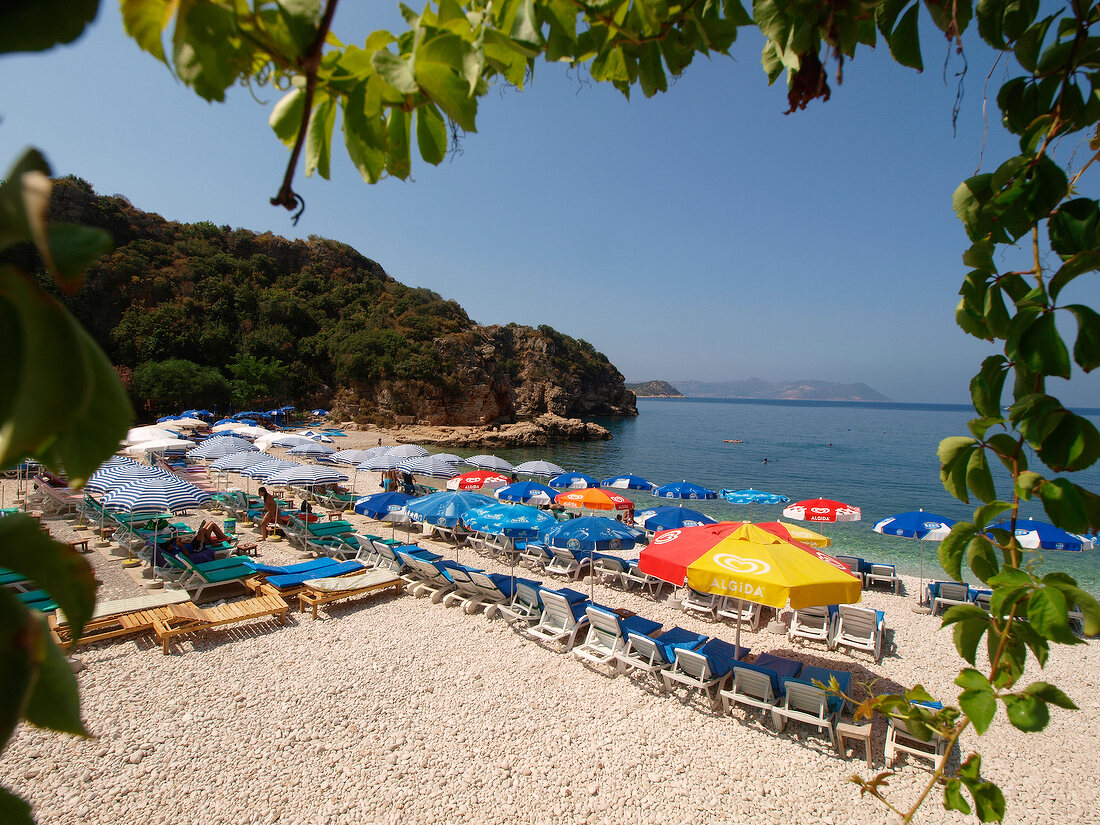 Sun loungers and umbrellas on bay beach