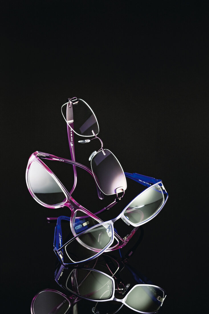 Various eyeglass frames on black background