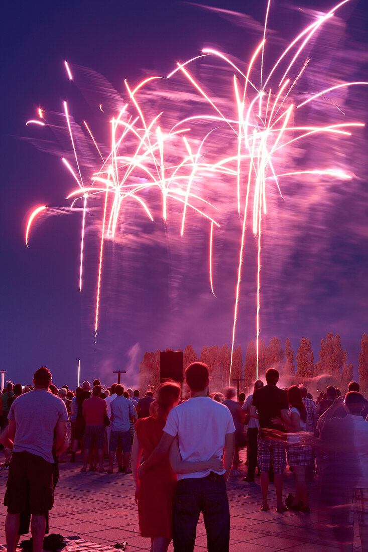 People enjoying evening fireworks in Bremen, Germany