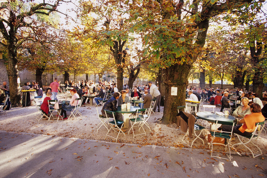 People at beer garden in the courtyard of Augustiner Brau, Salzburg, Austria