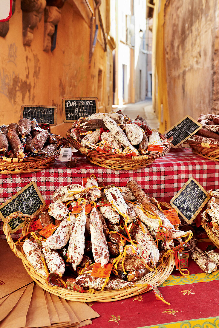 Close-up of salami in basket in market stall