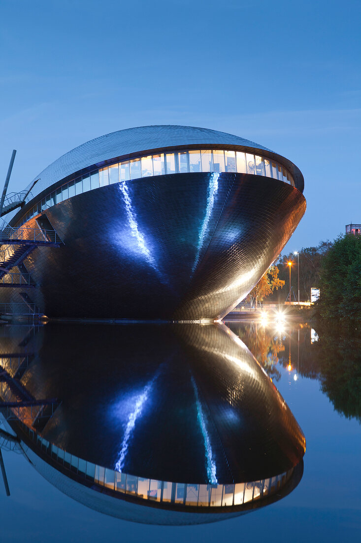 Symmetrical reflection of Atlantic Hotel Universum at night, Bremen, Germany