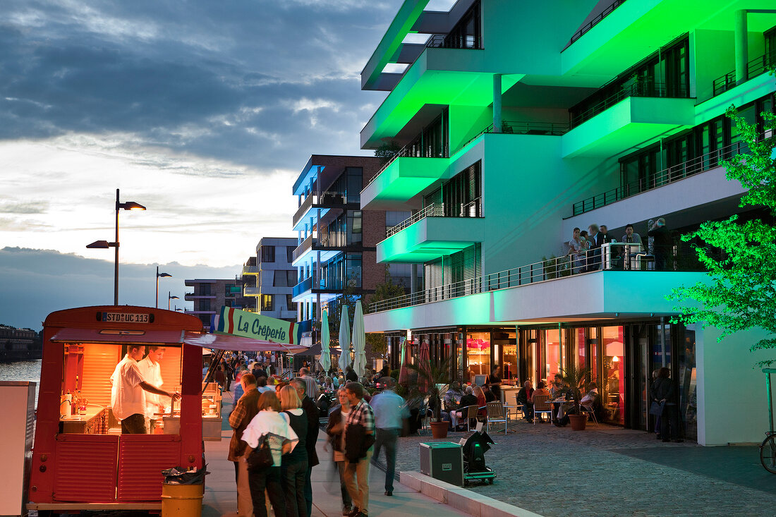 People at illuminated promenade in Bremen, Germany