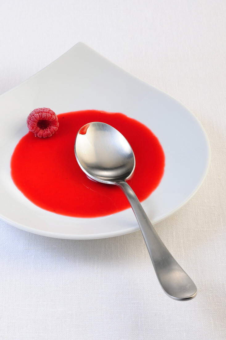 Raspberry with sauce on plate