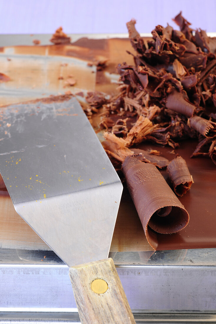 Close-up of chocolate rolls and spatula for preparation of desserts