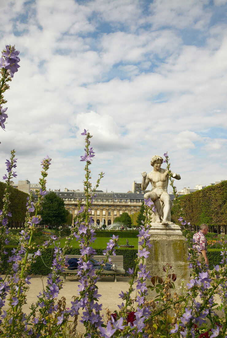 People sitting in garden of Palais-Royal, Paris, France