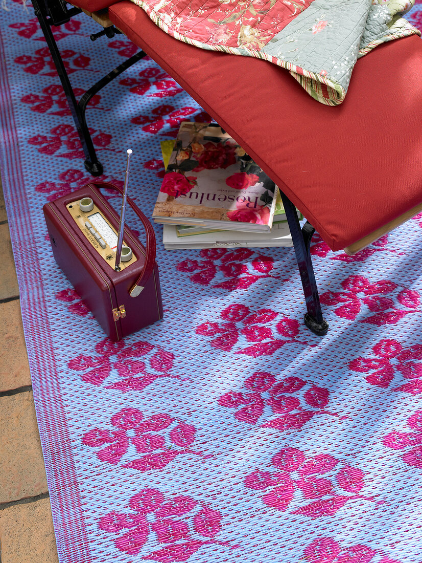Portable radio on carpet beside deck chair