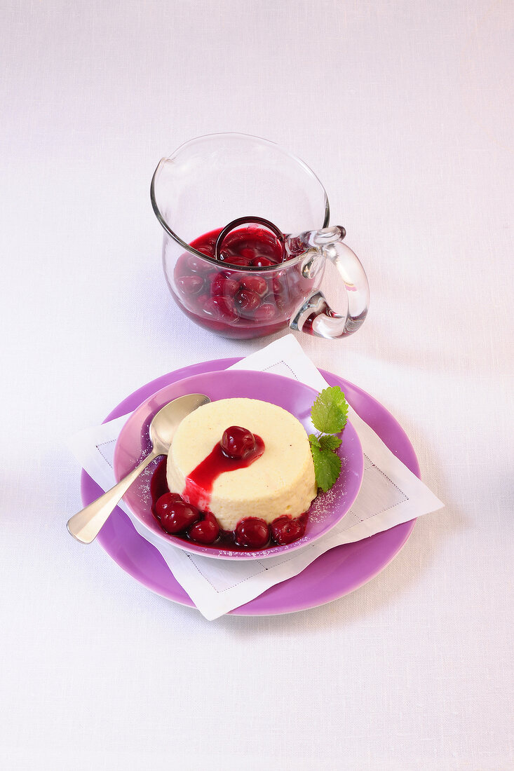 Vanilla semolina pudding with cherries on plate