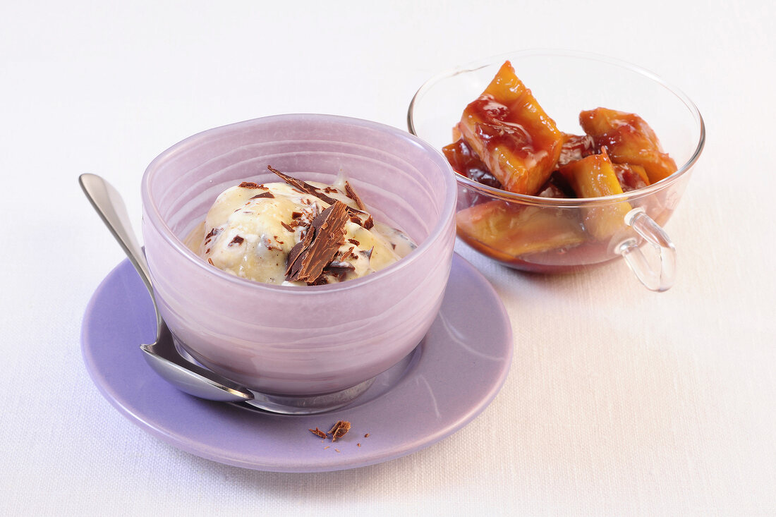 Ice cream with chocolate flakes in bowl and red wine rhubarb in glass cup