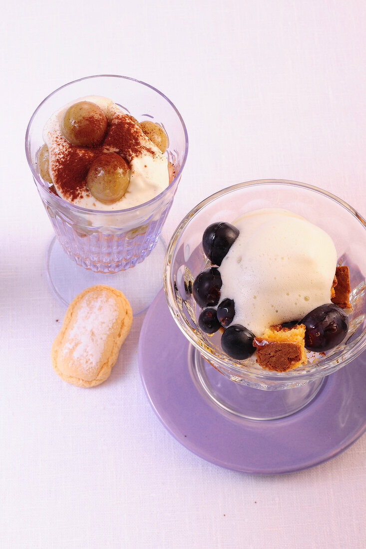 Goat cheese cream in bowl and zabaglione, grapes with gooseberries in glass