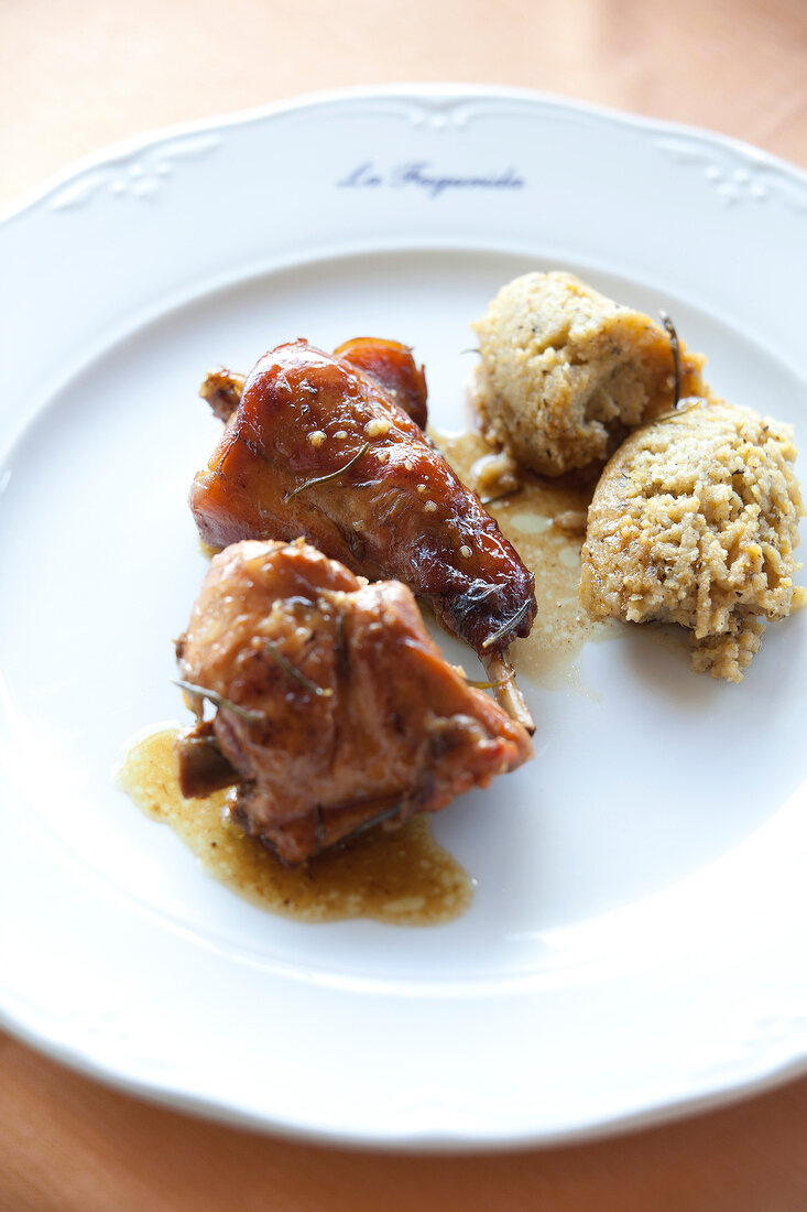 Close-up of rabbit with polenta on dish at Restaurant La Fagurida, Tremezzo, Italy