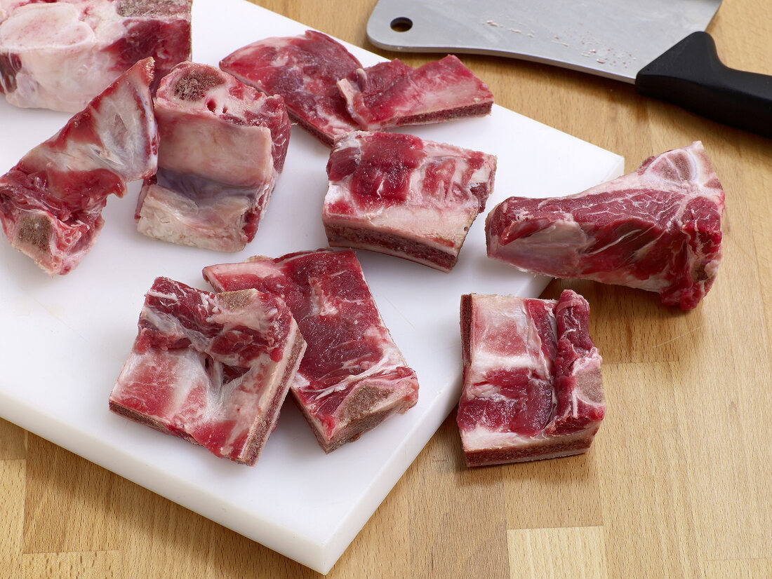 Pieces of cattle carcasses on chopping board