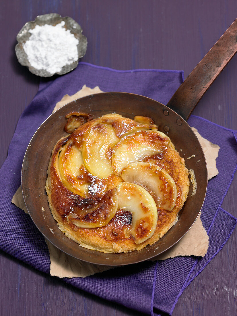 Caramelized apple pancakes in pan 