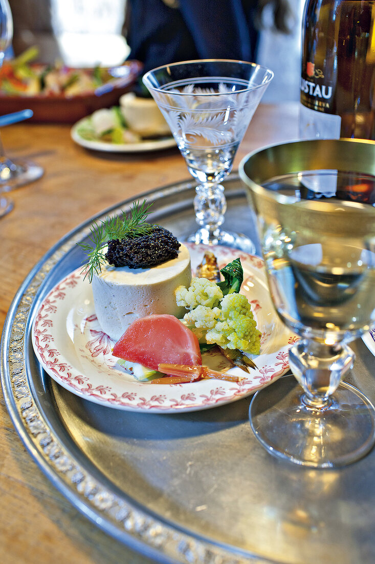 Kieler sprotten mousse served with drinks on plate