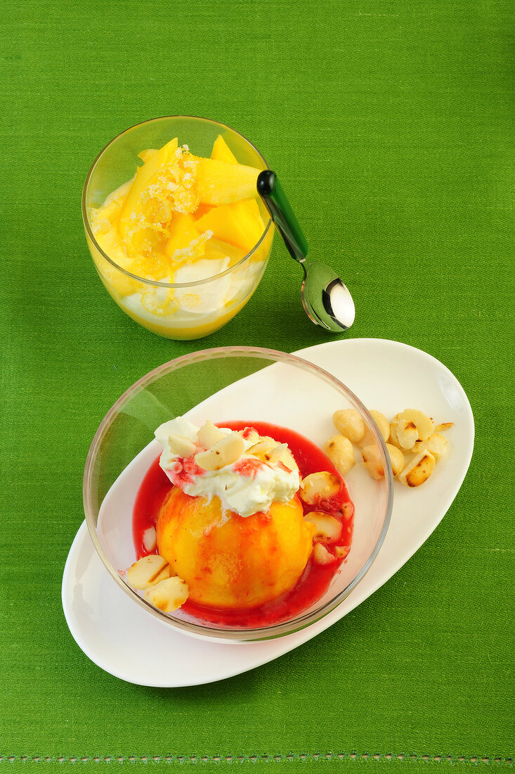 Mango cream in glass and peach melba in glass bowl