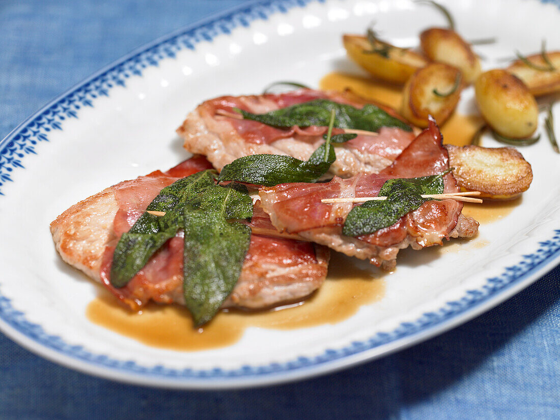 Close-up of saltimbocca with leaves on plate