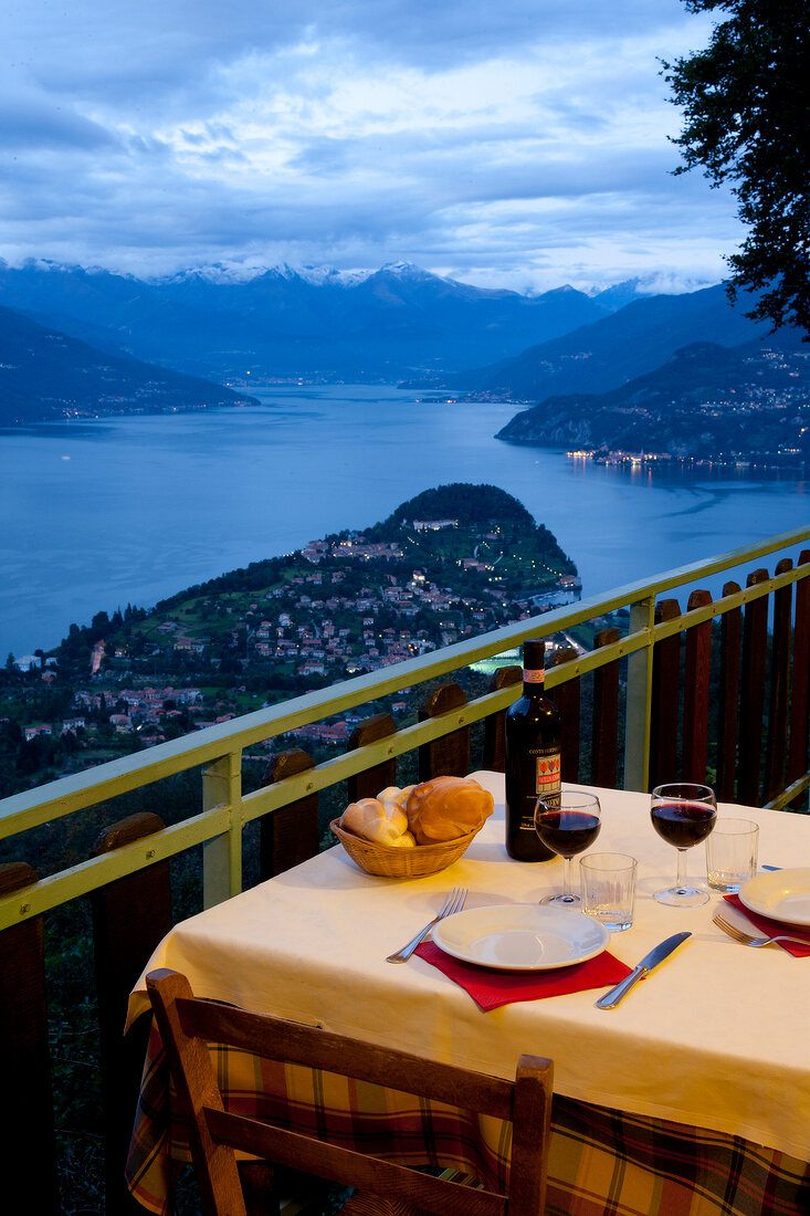 Table laid on terrace of Baita Belvedere restaurant overlooking Lake Como, Lombardy, Italy