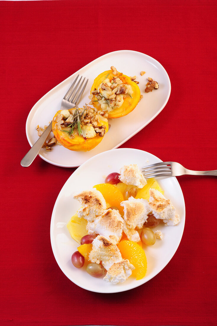 Peaches au gratin and fruit salad on plates