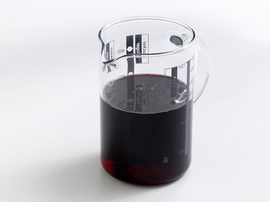 Blood in measuring cup on white background