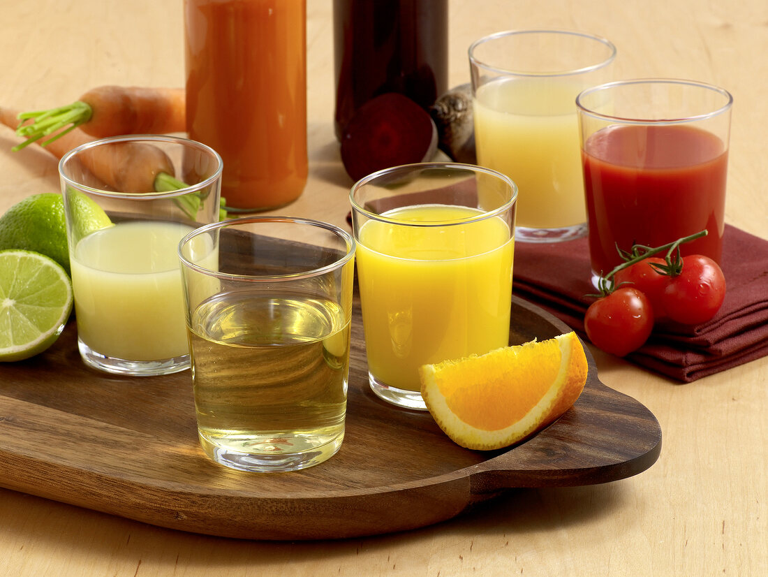 Different types of fruit and vegetable juices in glasses