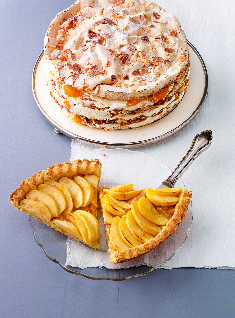 Layer cake and apple tart on plates