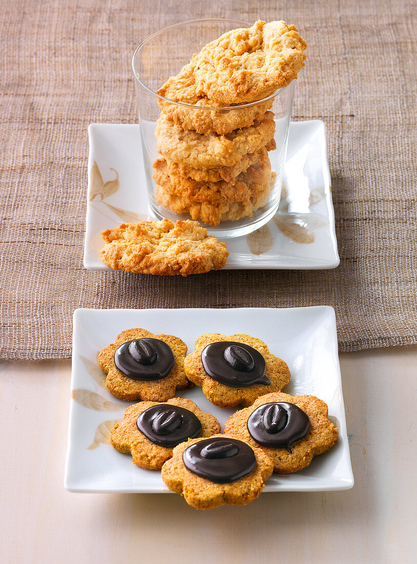 Peanut cookies in glass and mocha cookies on plate