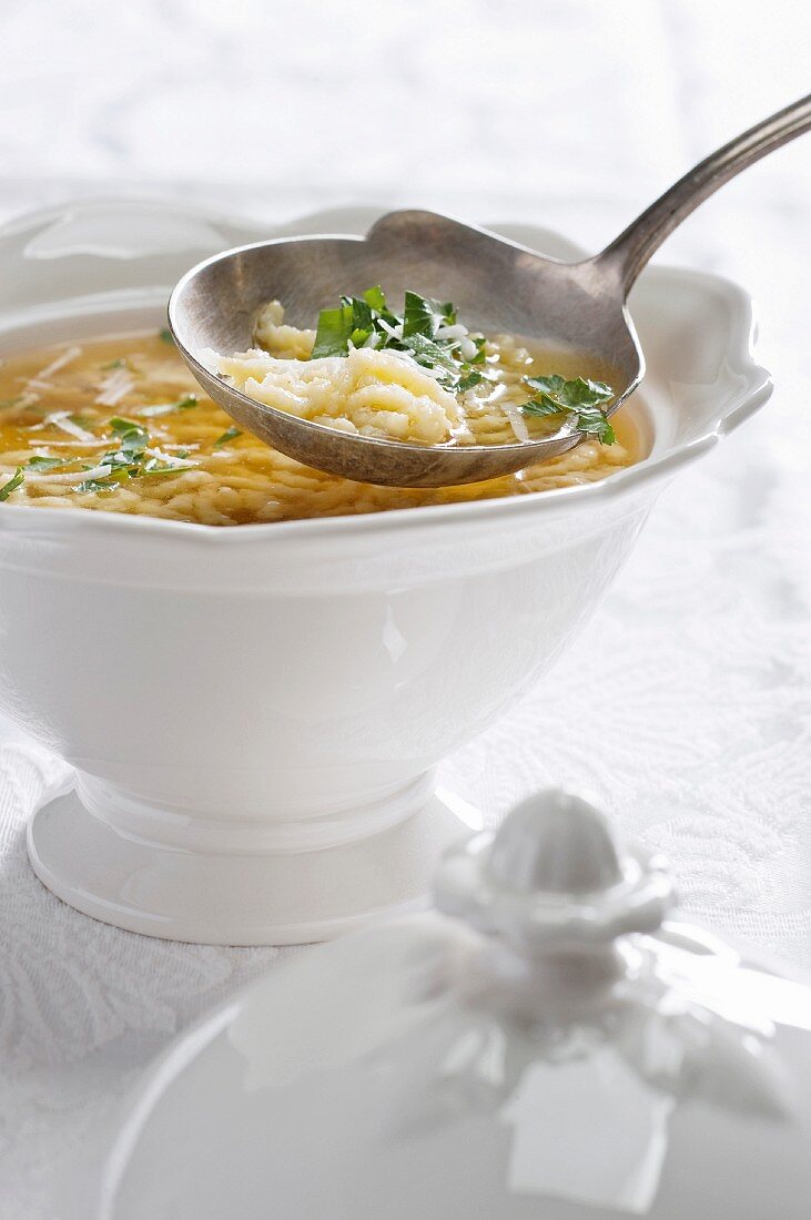 Pieces of pastry in broth with parsley (Italy)