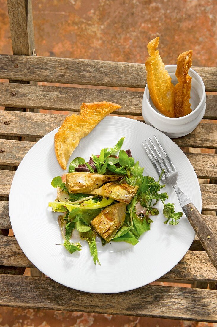 Artichokes on a bed of wild herbs served with white bread