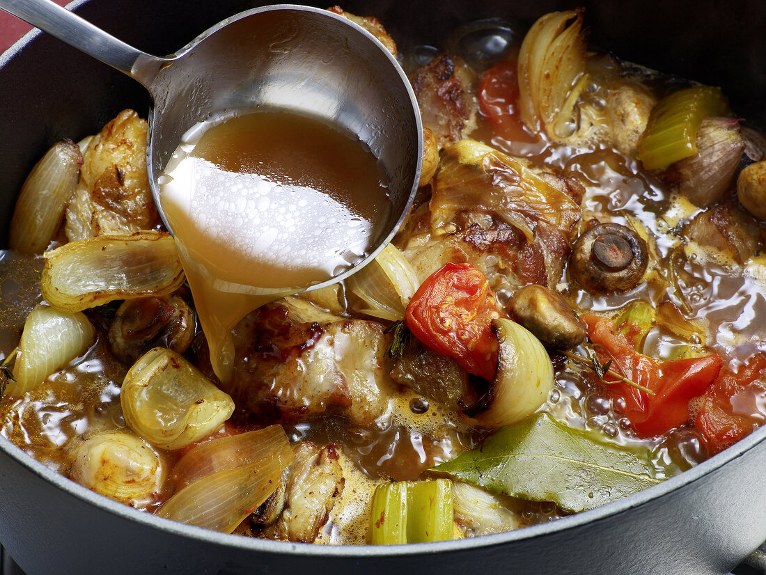 Close-up of liquid in ladle for preparation of veal jus, step 7