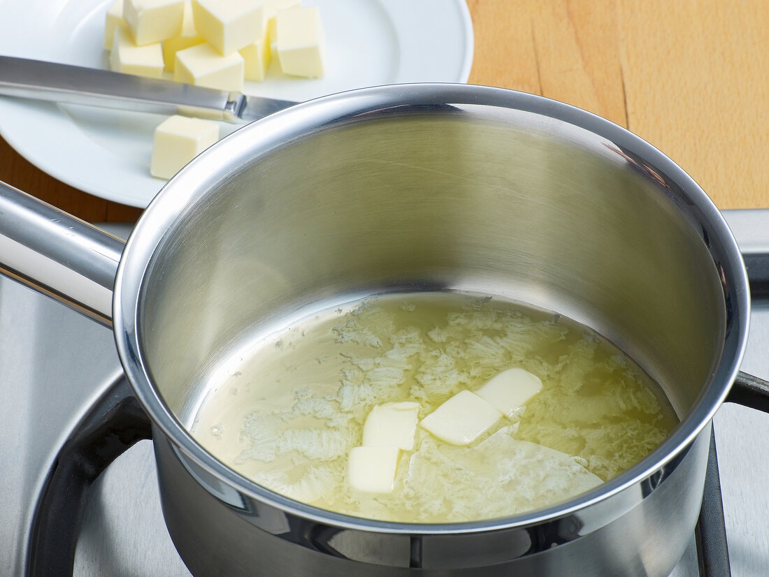 Butter being melted in pan for preparation of white roux, step 1