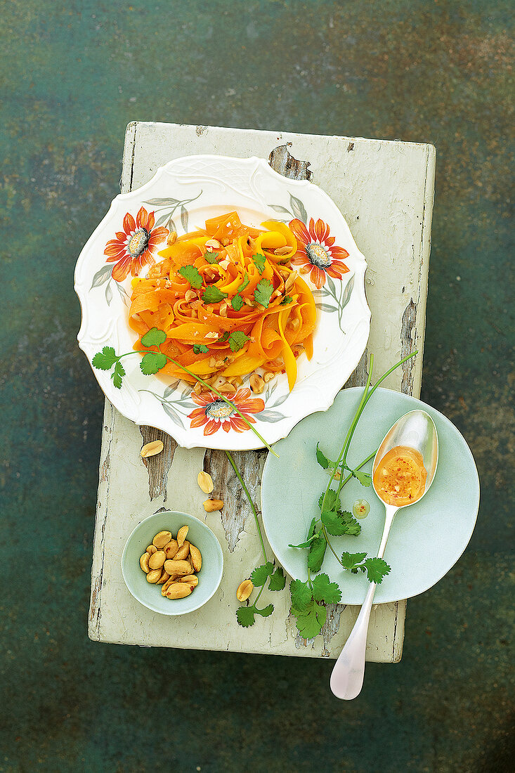 Thai mango carrot salad with peanuts on serving dish