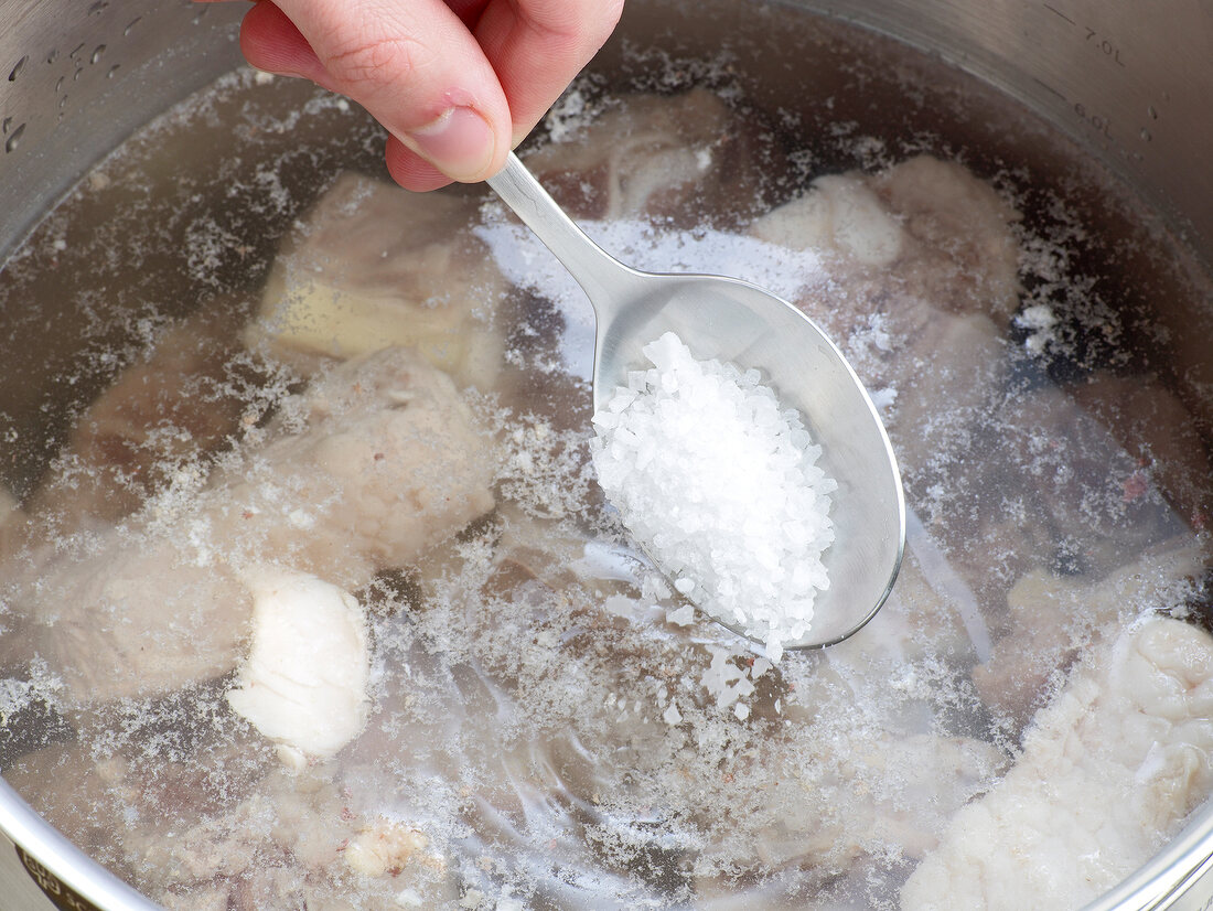 Close-up of sugar being added in mixture for preparation of beef stock, step 3