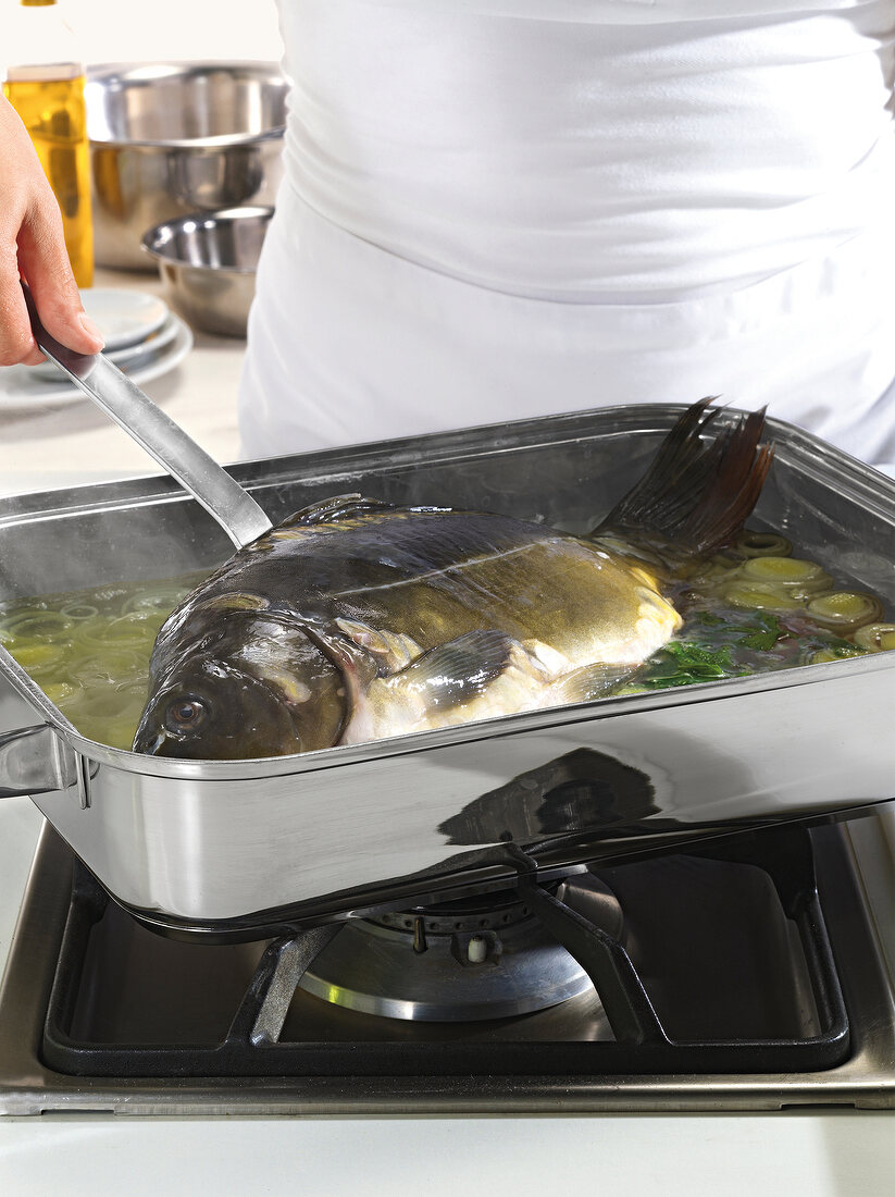 Close-up of carp fish being cooked with vegetables