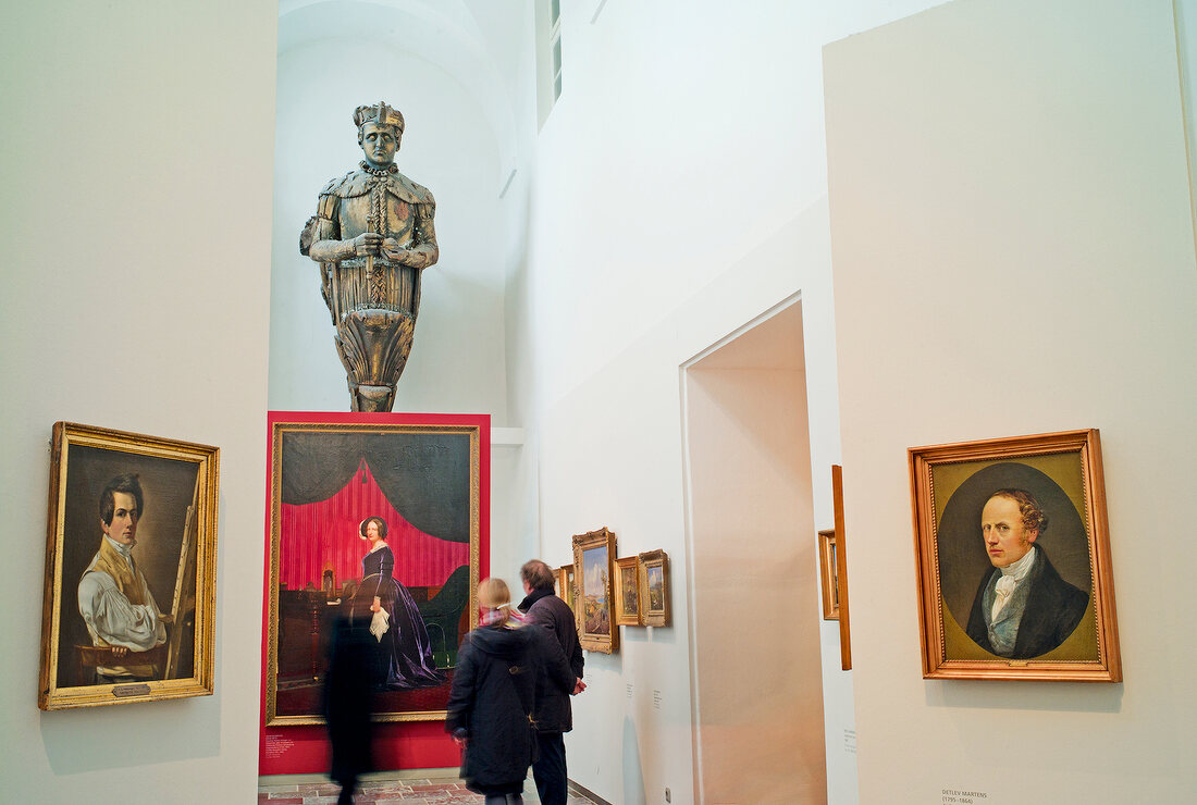 Visitors looking at paintings in exhibition, Baltic Sea Coast