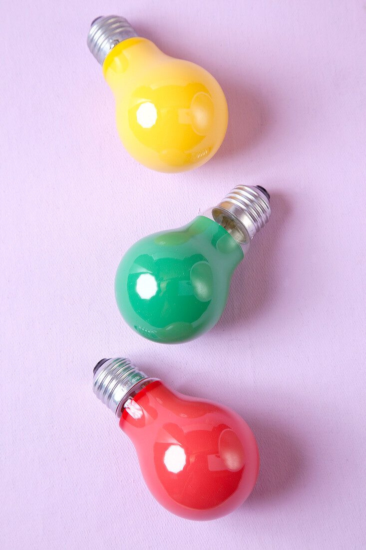 Red, yellow and green bulb on pink background