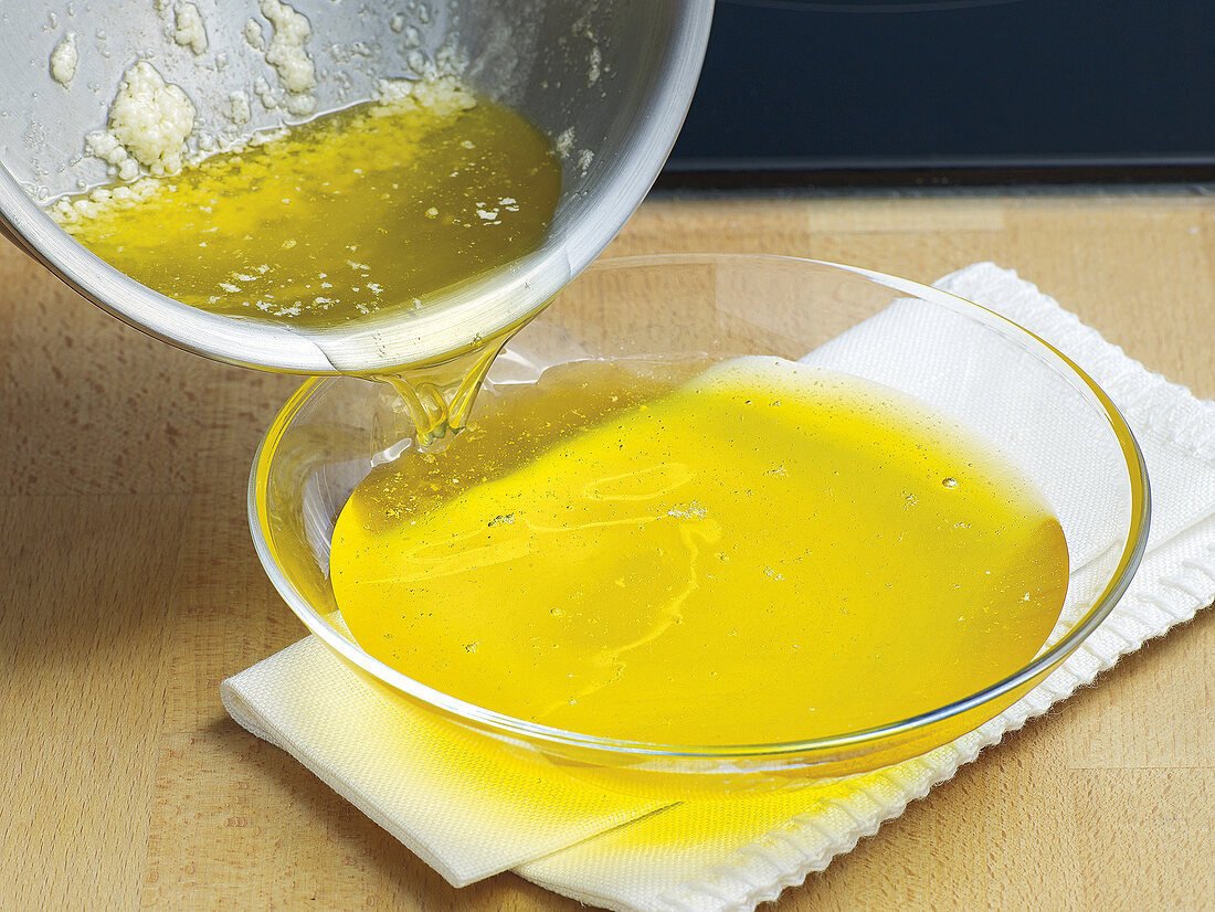 Pouring clarified butter in glass dish, step 3