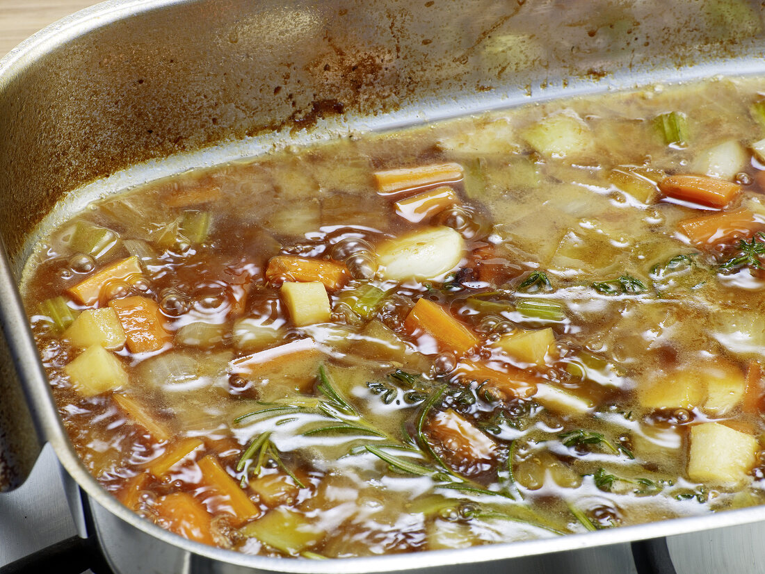 Close-up of mixture being boiled in pan for preparation of bratenjus, step 5