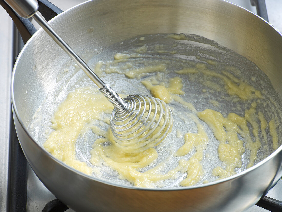 Close-up of butter being stirred in pan for preparation of poultry veloute, step 1