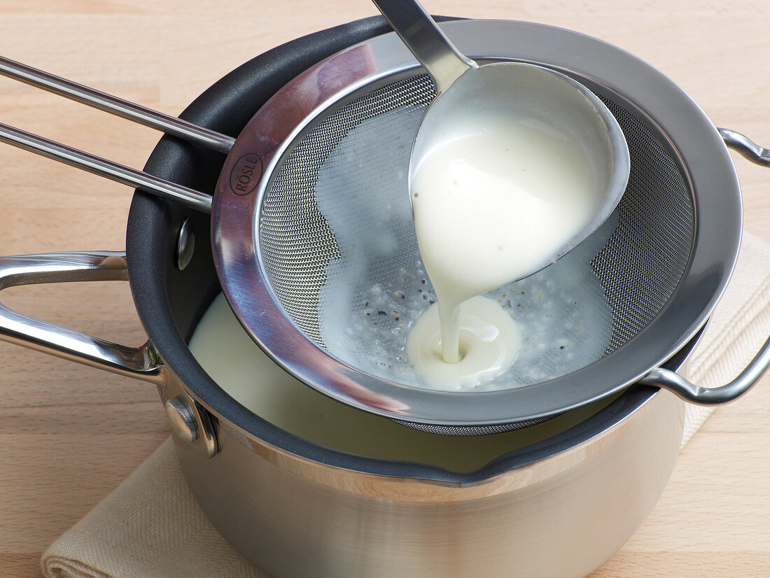 Mixture being filtered from sieve in pan for preparation of poultry veloute, step 5