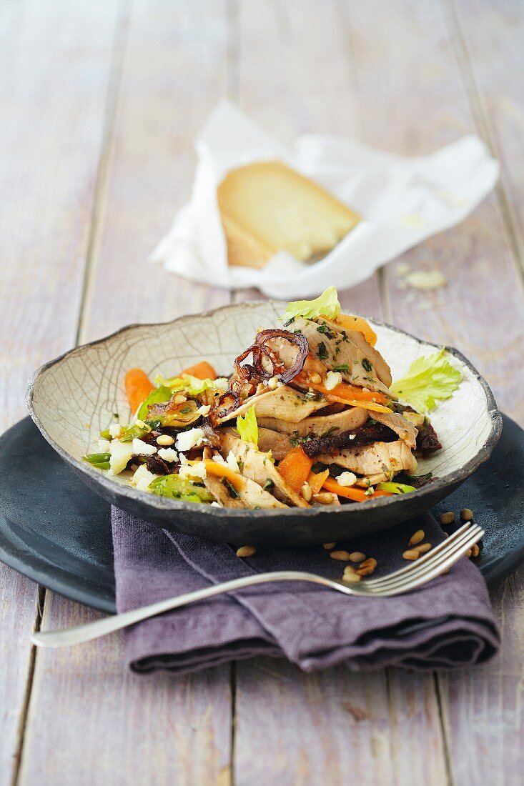Mediterranean salad with roast pork, carrots and dried tomatoes