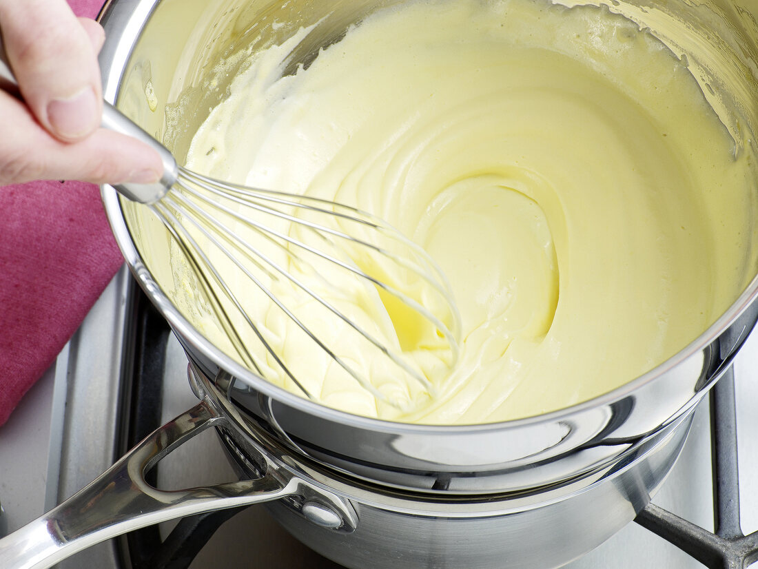 Mixture being whisked for preparation of hollandaise sauce, step 4