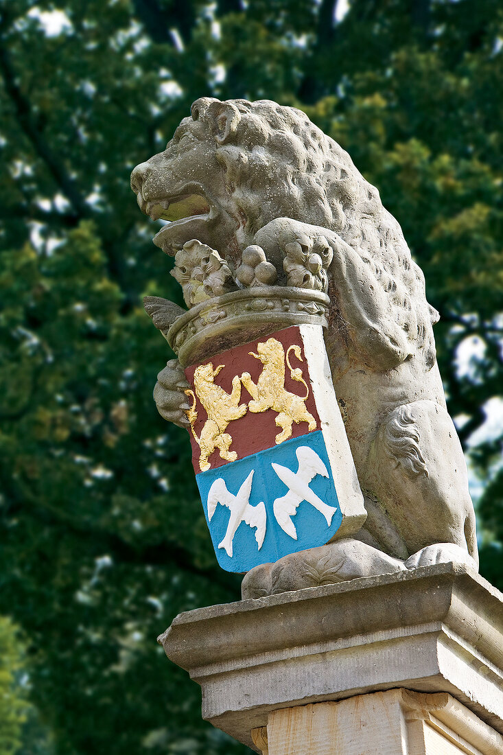 Close-up of stone lion with coat of arms at Baltic Coast mansion