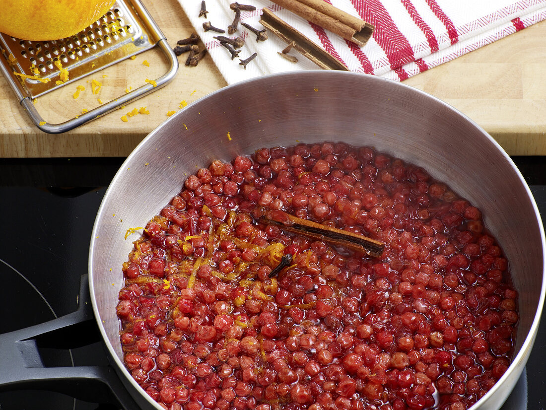 Close-up of cranberry with spices in saucepan for preparation of cranberry cream, step 1