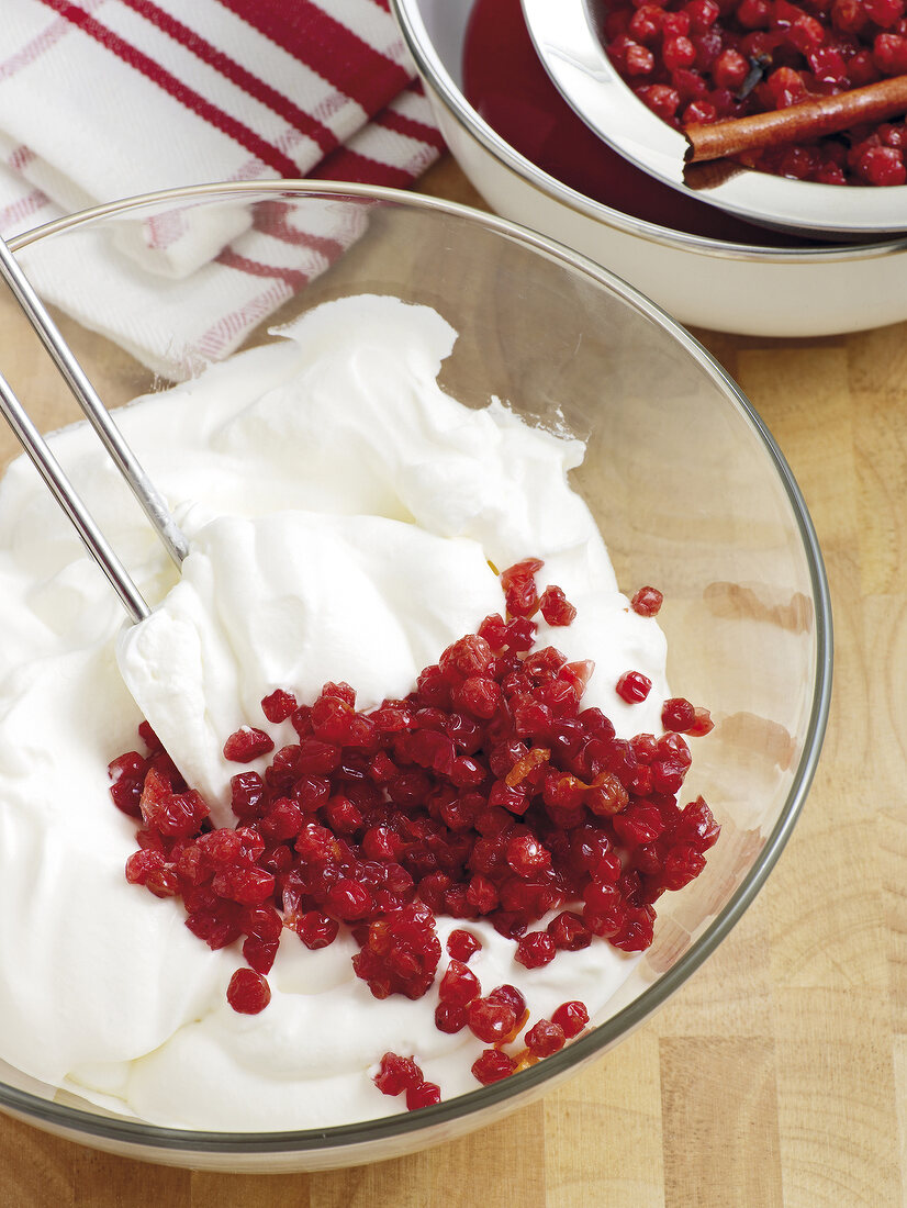 Cranberry and cream being mixed with spatula in bowl, step 2