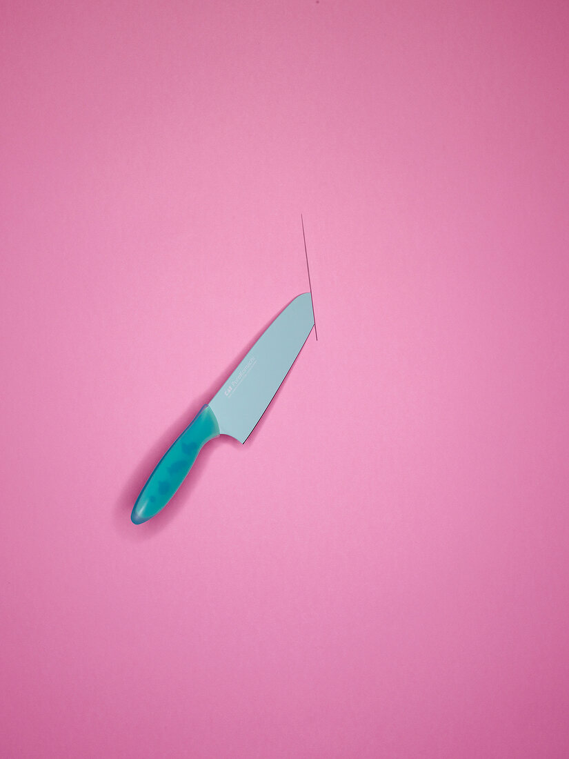 Santoku knife on pink background