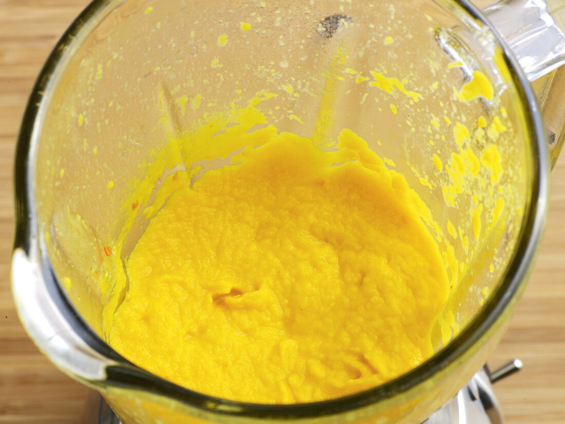 Close-up of carrot coulis in grinder, step 3