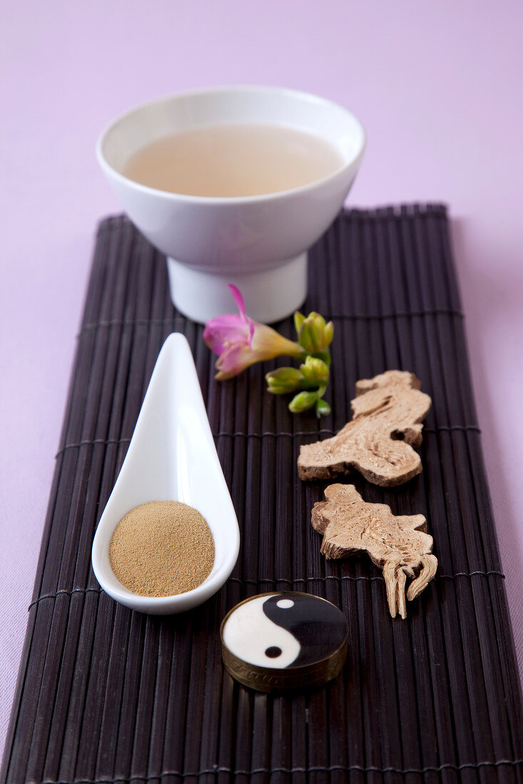 Various herbal Japanese healing medicines on pink background, overhead view