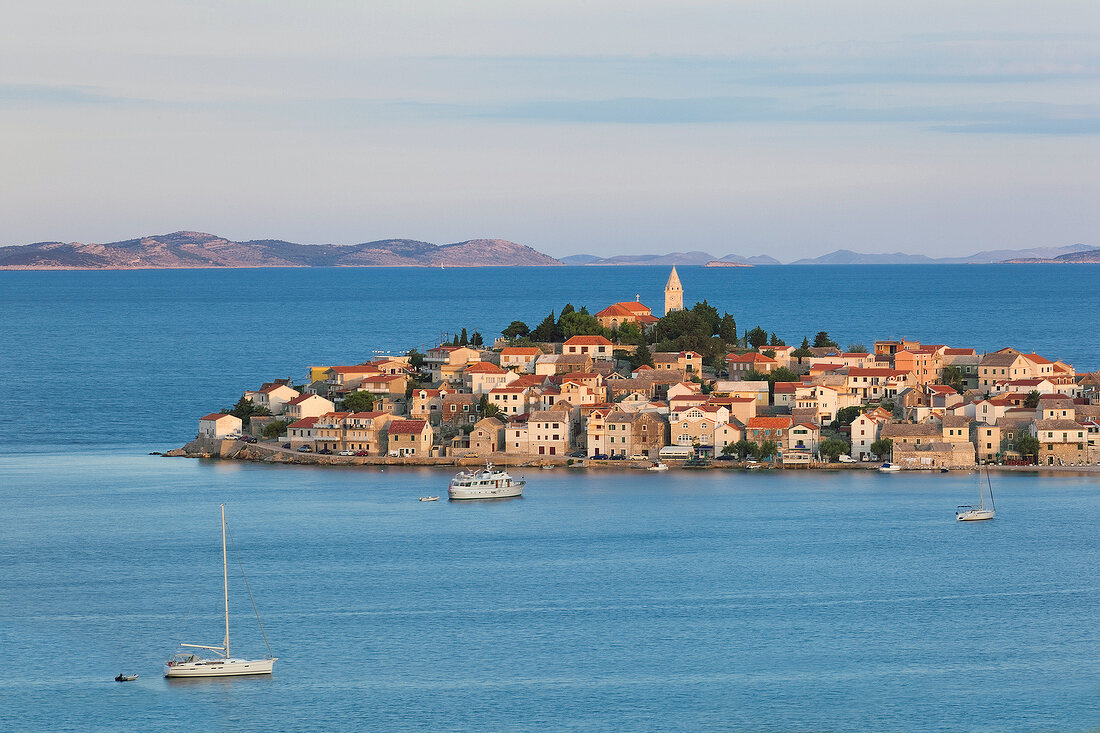 View of Primosten town and mountains on the horizon of Adriatic sea in Croatia