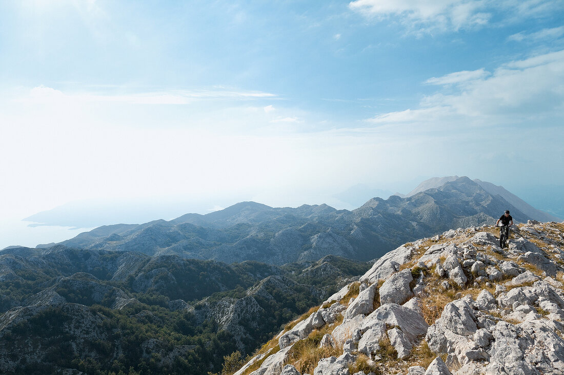 Biker riding bike on Mount Sveti Jure in Dalmatia, Croatia