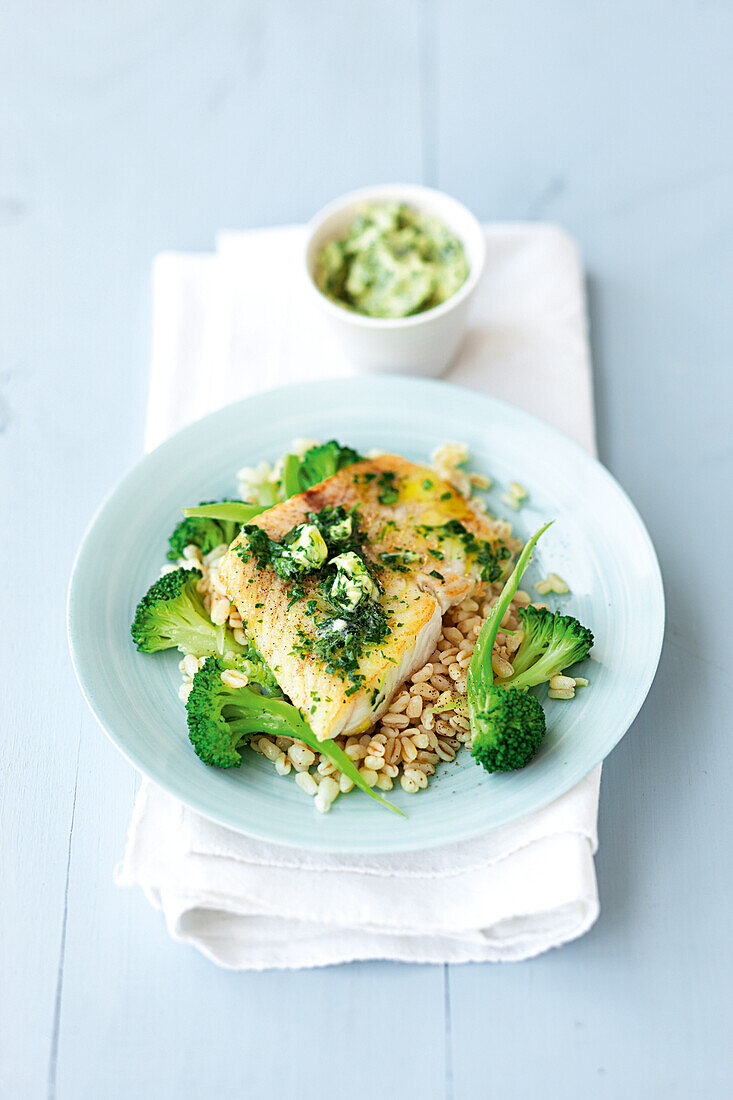 Fried fish fillet with wheat, broccoli and herb butter